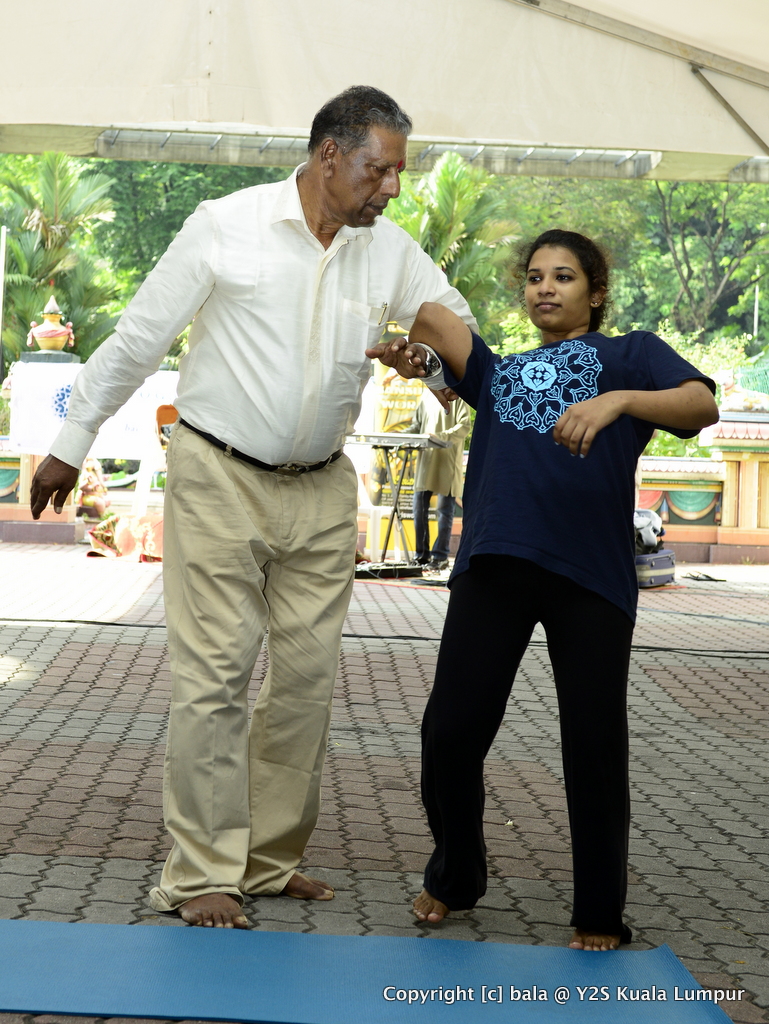 Gurukkal demonstrating self-defense techniques, with Aditi Manoharan